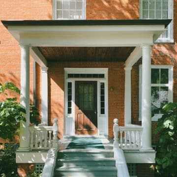 brown brick house with white wooden door